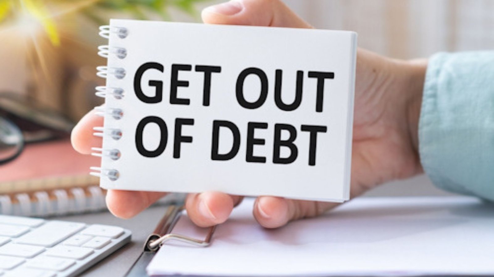A Hand Holding a Get Out of Debt Card 